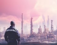 An industrial workers silhouette in front of a city on top of an