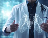 The doctor wearing a white coat holds hand displaying an image of the lung in the foreground of the screen, health and medical stock image