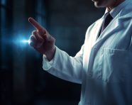 Doctor in white coat holding finger, health and medical stock image