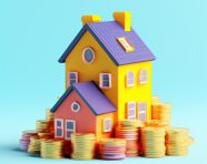 A photo of a stack of coins with a house on top of it, home loan stock image