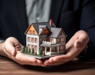 A photo of a concept of mortgage by house in hand with, home loan stock image