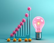 A photo of a graph and a light bulb blue background, finance stock photo