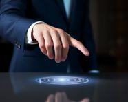 A businessman in a suit is pointing at a button, seo stock images for marketing campaigns