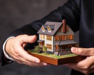 A photo of a hand holding a house new offers in the real estate market, home loan stock image