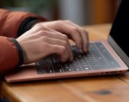 Typing on laptop using wireless technology indoors, seo stock images for marketing campaigns