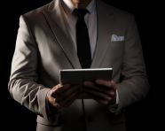 Man holding tablet computer on black background