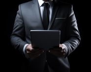Man holding tablet computer on black background, seo stock images for marketing campaigns
