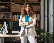 A photo of a successful young businesswoman standing in the office presenting, free ai prompts for hr