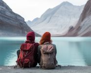 Two hikers enjoying the peace and quiet of a mountain lake, adventure travel stock images, adventure travel ai prompts, travel stock images ai