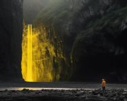 Hiker standing in front of waterfall on mountain, adventure travel stock images, adventure travel ai prompts, travel stock images ai