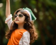 A young girl wearing a patriotic outfit and saluting, independence day stock image, independence day ai prompt