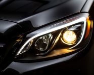 Car headlights illuminate the night, assembly line car production, assembly line car manufacturing