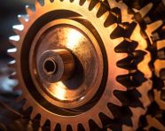 A close-up of a cogwheel, with the teeth of the wheel in sharp focus and the background blurred, industrial machinery stock images ai, midjourney prompt ideas