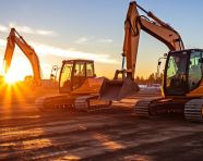 A construction site with two heavy wheeled tractors one excavator and other machinery, industrial machinery stock images ai, midjourney prompt ideas