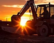 A silhouette of a construction worker against the setting sun with a bulldozer, industrial machinery stock images ai, midjourney prompt ideas
