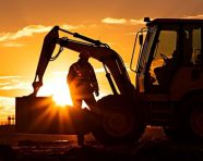 Construction worker silhouetted against the setting sun, industrial machinery stock images ai, midjourney prompt ideas