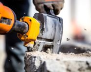 Jackhammer teeth bite into concrete, industrial machinery stock images ai, midjourney prompt ideas