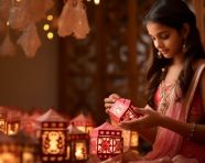 A girl in ethnic clothing is holding an indian paper lamps, diwali festival stock image, diwali festival ai prompt