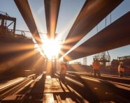 High-angle shot of crane lifting steel beams, industrial machinery stock images ai, midjourney prompt ideas