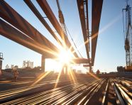 Crane in foreground lifting steel beams, industrial machinery stock images ai, midjourney prompt ideas
