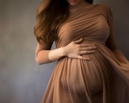 Beautiful pregnant woman in brown dress celebrates her pregnancy, pregnant women pictures, maternity photos