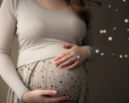 Pregnant woman holding belly and holding a pen, pregnant women pictures, maternity photos