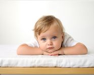 Smiling baby in s sitting on a white background, ai baby prompt, baby ai art