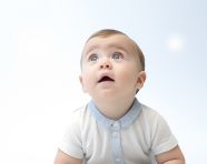 Baby boy in white shirt sitting still on white background, ai baby prompt, baby ai art