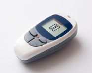 Checking blood sugar with a glucose monitor, diabetes concept