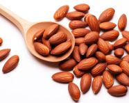 Image of almonds in a wooden spoon on a white background, almond image