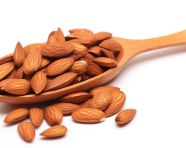 Almonds in wooden spoon on white background, almond image