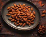 Almonds on plate on table on concrete, almond image