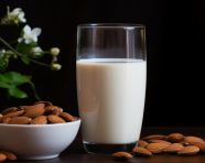 Glass of almond milk on white background, almond image