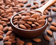 A bowl of almonds with a spoon, almond image