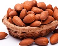 A basket of freshly picked almonds sits on a white background, almond image
