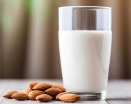 Glass of almond milk in the distance, almond image