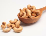 Cashew nuts in a wooden spoon on a white background, cashew image