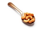 A spoon with cashews on a white background, cashew image