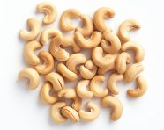 Abundance of roasted cashews on white, cashew image