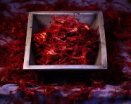 Saffron flakes in a white bowl, saffron flower image