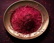 Small dish of saffron with seeds on white plate, saffron flower image