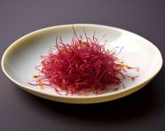 Saffron seeds in a small dish, saffron flower image