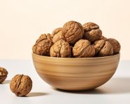 Walnuts in a bowl on top of a white background, walnuts image