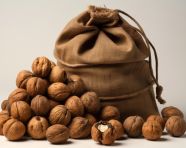 Walnuts in a burlap bag with holes and nuts, walnuts image