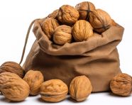 Walnuts in a bag sitting on top of a white background, walnuts image