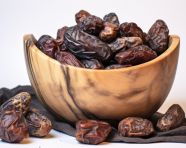 Bowl of sweet dates on white background, sweet dates image
