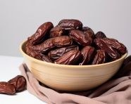 Dates in a brown bowl on white, sweet dates image