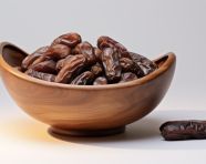 Brown bowl of dates on white, sweet dates image