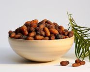 A bowl of dates on a white background, sweet dates image