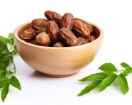 Dates in date bowl with green leaves on white background, sweet dates image